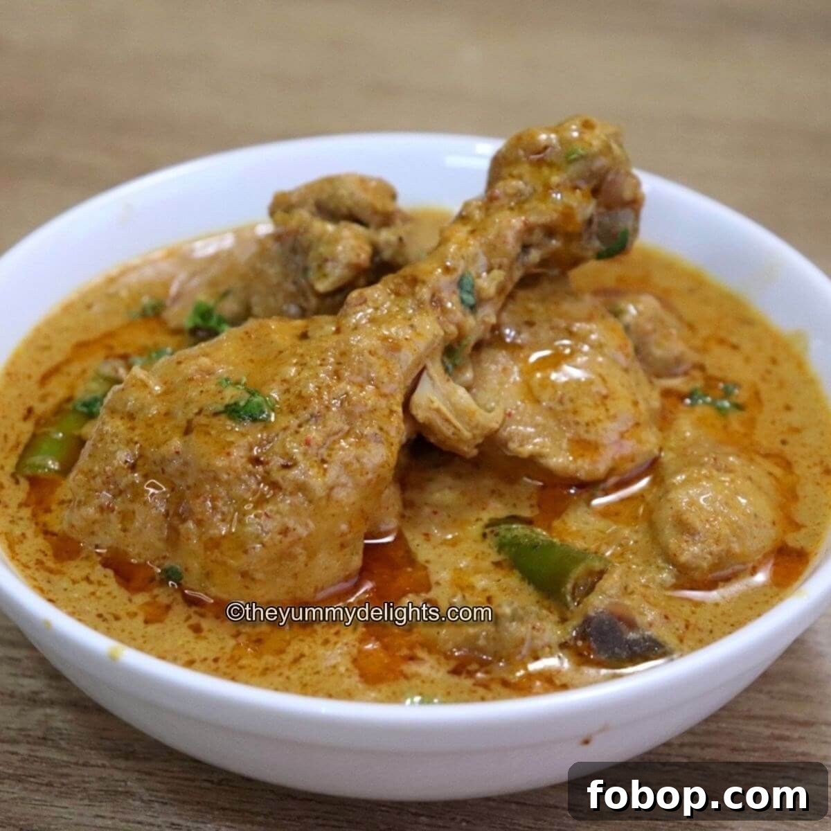 hyderabadi chicken korma served in a white bowl.