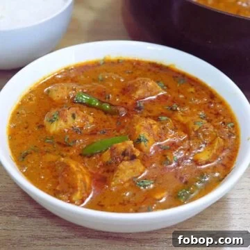 chicken handi served in a white bowl.