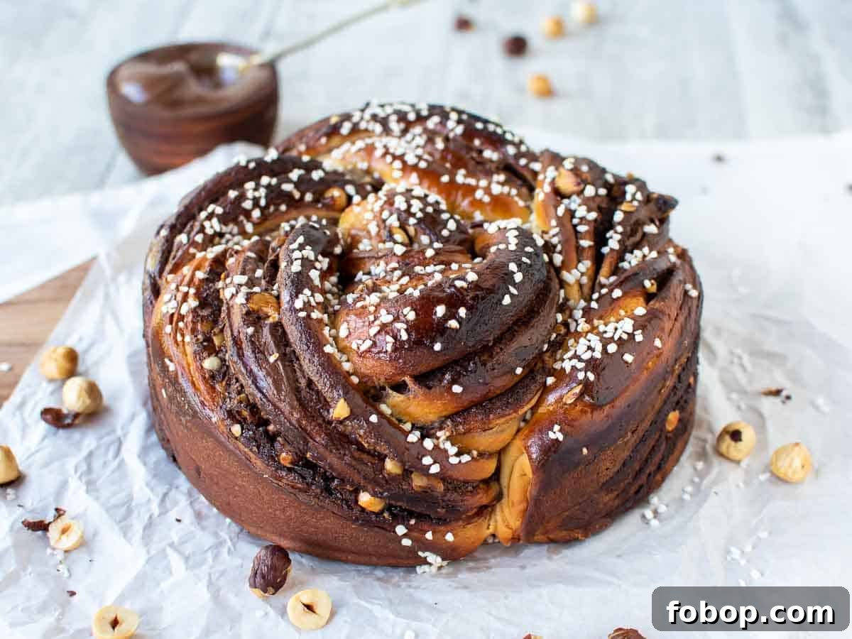 Whole golden brown round bread with white pearl sugar on top.