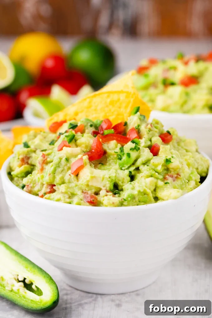 Mexican guacamole topped with chopped tomatoes, jalapenos, and onion.