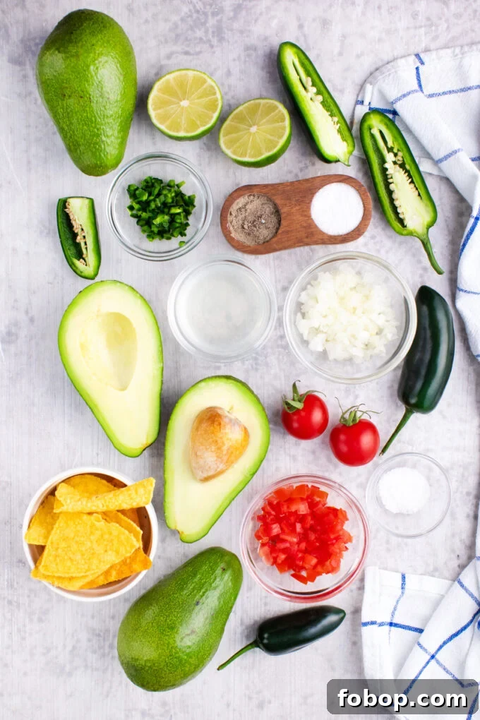 Overhead shot of guacamole recipe ingredients on a table.
