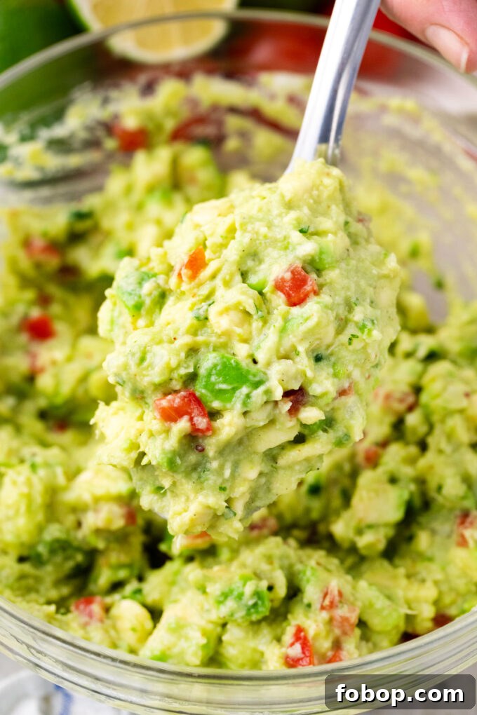 A spoonful of creamy and chunky guacamole.