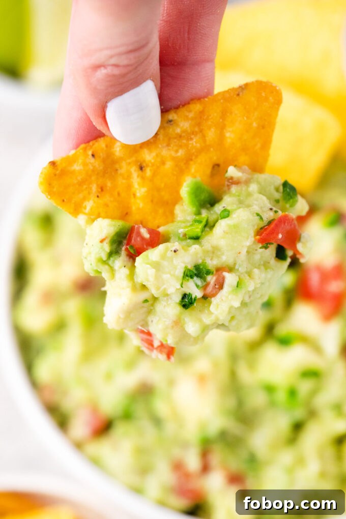 Homemade guacamole on a corn chip.