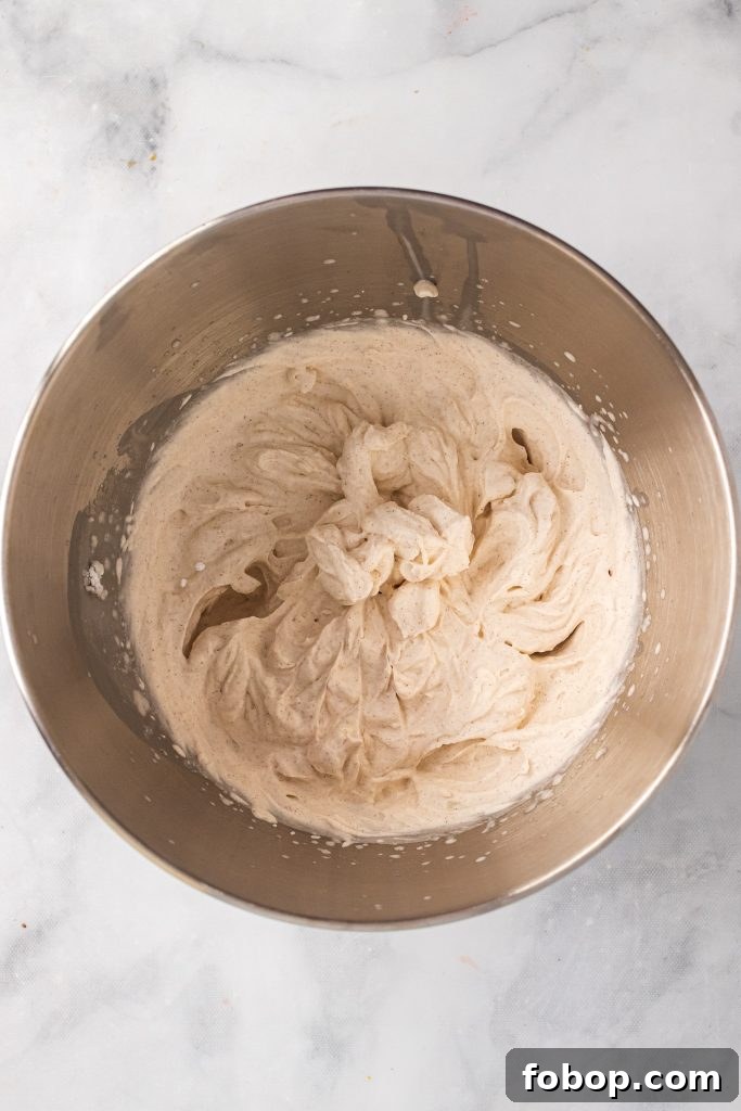 cinnamon whipped cream in stainless steel mixing bowl
