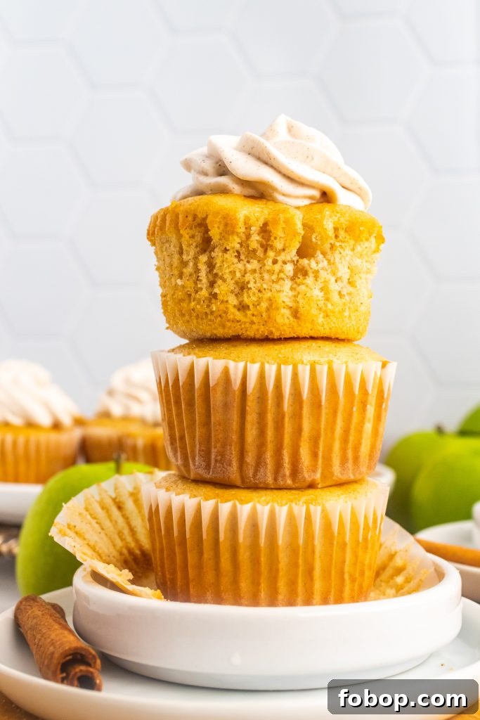 a stack of three apple pie cupcakes on a small white plate