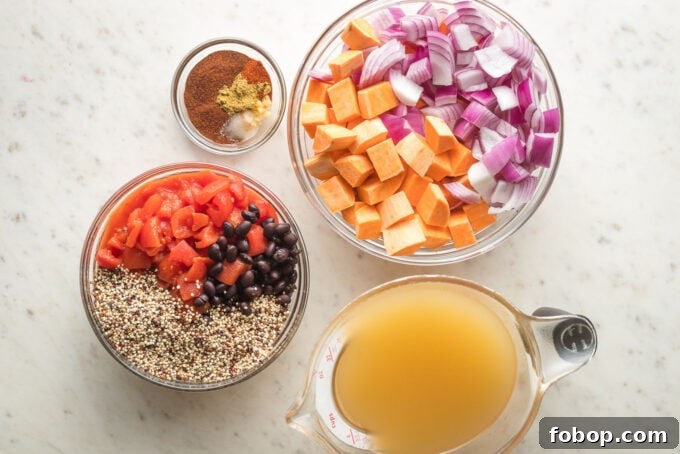 Sweet Potato and Black Bean Chili Recipe for Cozy Weeknights 3 Prep bowls containing red onion, sweet potato, diced tomatoes, black beans, quinoa, veggie broth, and chili seasonings.
