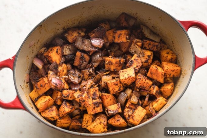 Sweet Potato and Black Bean Chili Recipe for Cozy Weeknights 5 Garlic and chili seasonings added to Dutch oven.