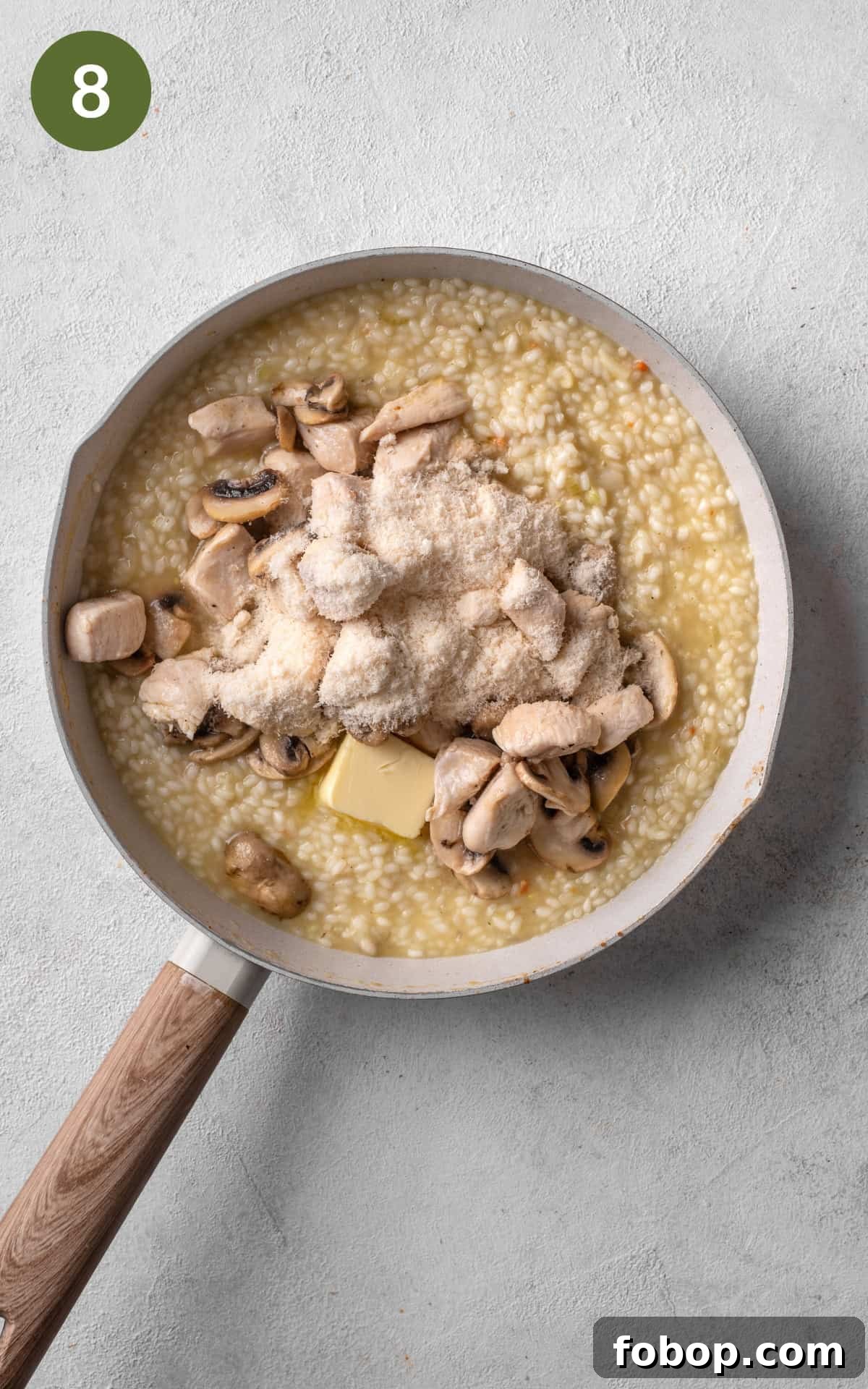 rice, chicken, and parmesan mixed in a skillet.