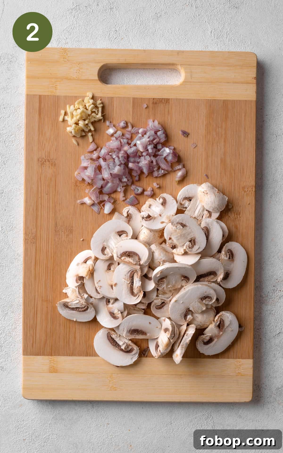 onions, mushrooms and garlic on cutting board.