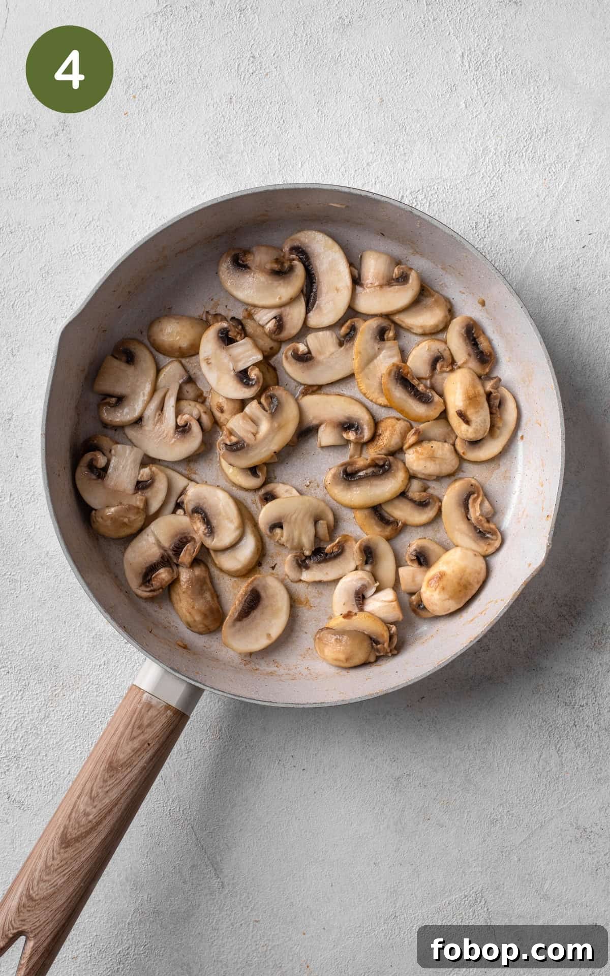 cooking chicken and mushrooms in a skillet.