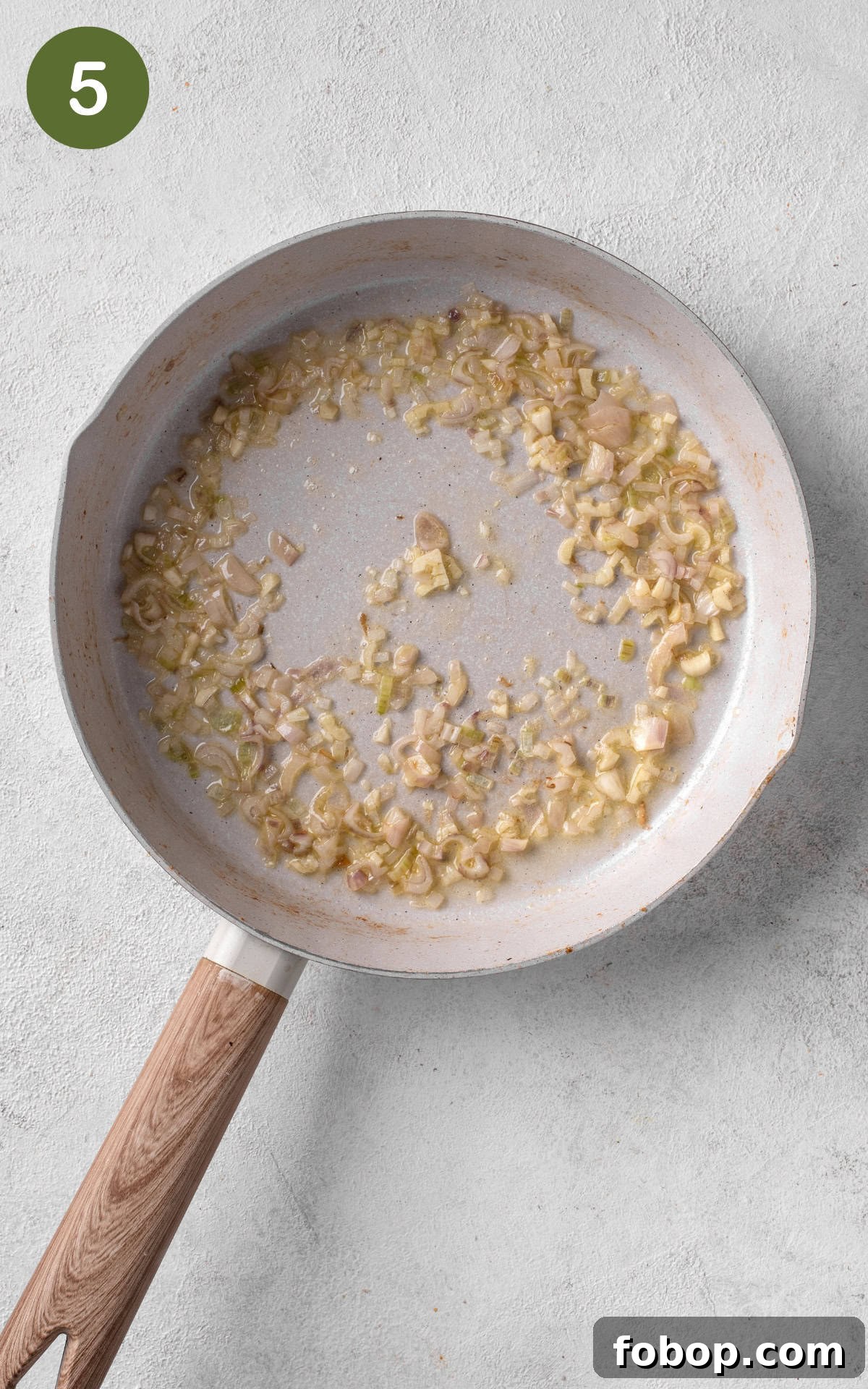 cooking shallots and garlic on a skillet.