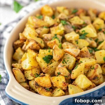 Crispy roasted potatoes in blue oval dish.