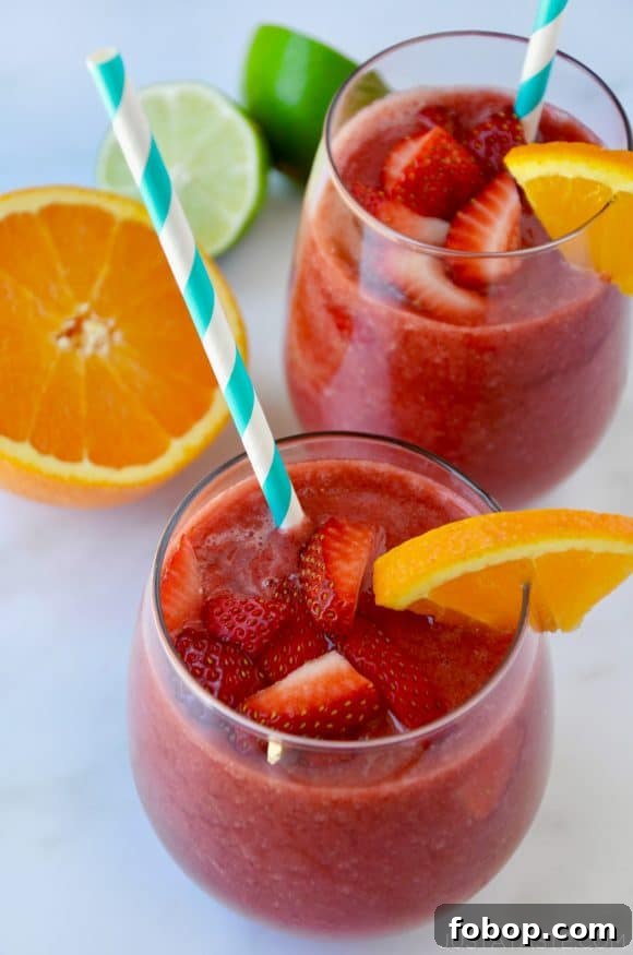 Frozen Sangria Recipe: Refreshing Frozen Sangria for Parties 2 The Best Frozen Sangria topped with fresh strawberries served with an orange slice and straw