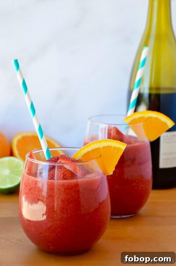Frozen Sangria Recipe: Refreshing Frozen Sangria for Parties 3 The Best Frozen Sangria with an orange slice and teal stripped straw