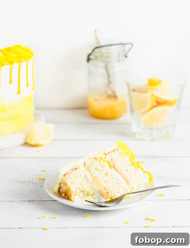 partially eaten slice of cake with cake and lemons in the background