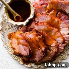 Slices of baked ham topped with brown sugar glaze on a platter.