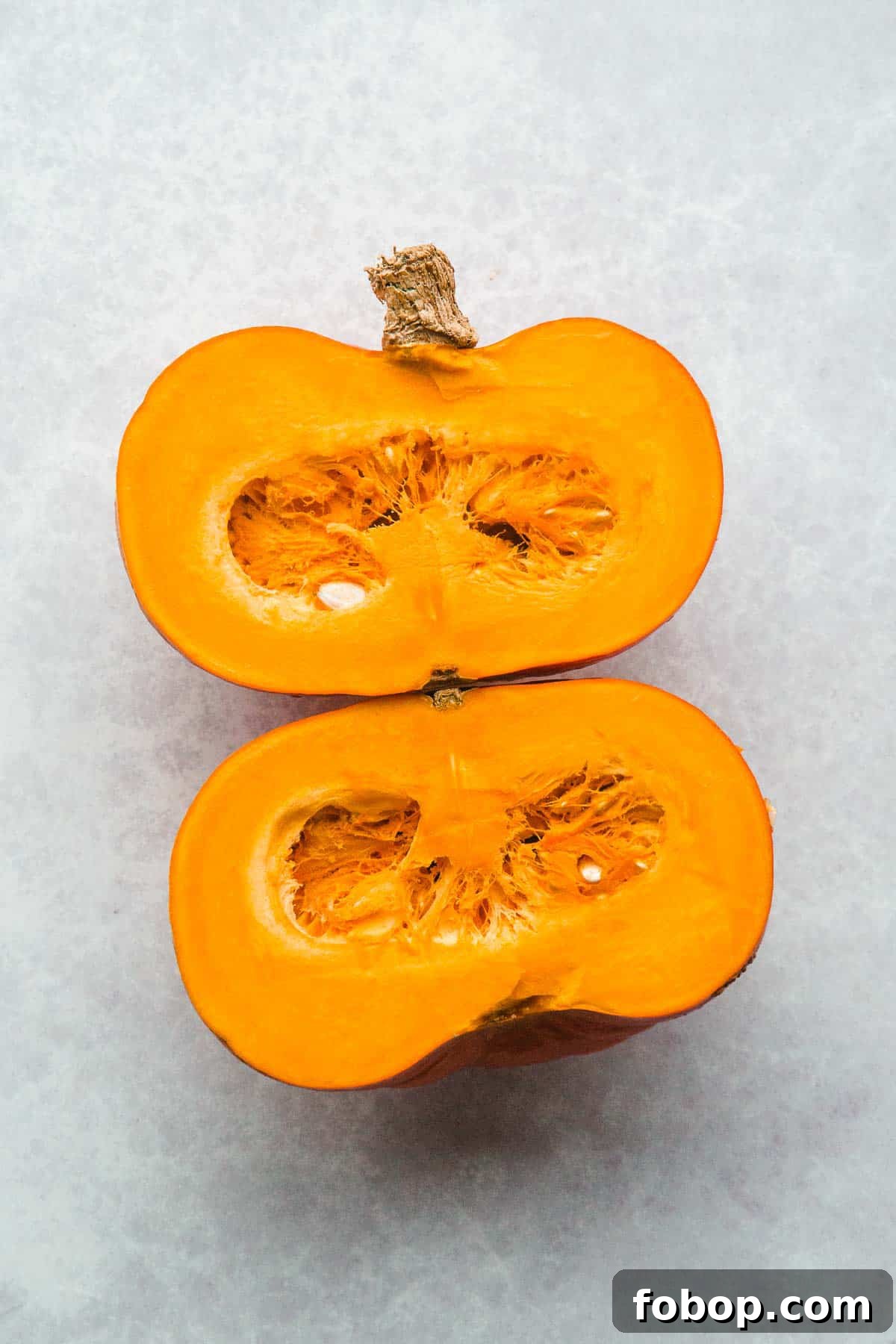 A pumpkin cut into two halves 