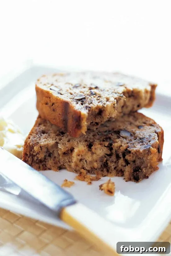 Perfectly Flaky Morning Buns: Cinnamon Sugar Pastry Recipe 5 A broken slice of banana bread stacked on a white plate
