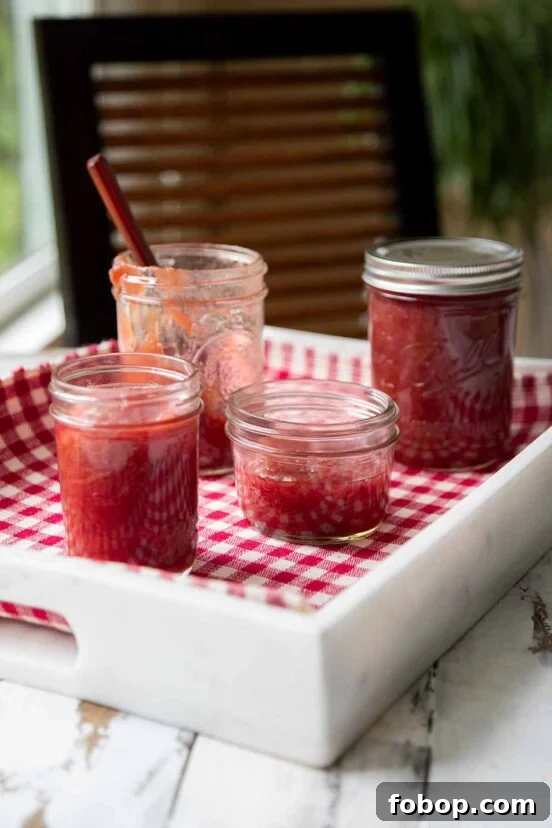 Perfectly Flaky Morning Buns: Cinnamon Sugar Pastry Recipe 6 Four jars of rhubarb jam on a white tray lined with checkered cloth.