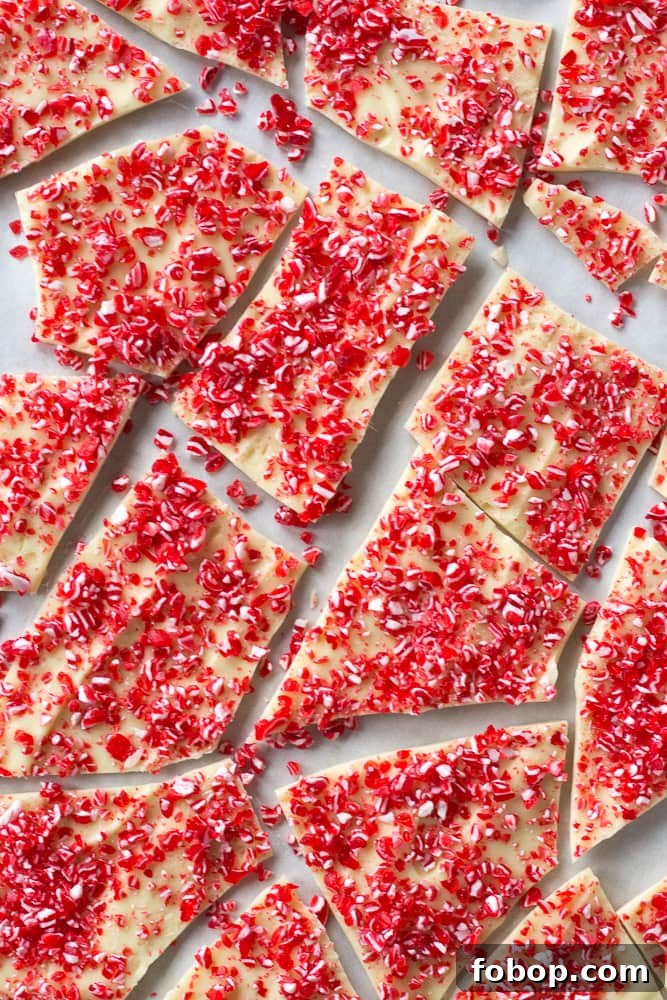 Gluten-Free White Chocolate Peppermint Bark Recipe 15 Broken pieces of white chocolate sprinkled with red and white peppermint candy bits.