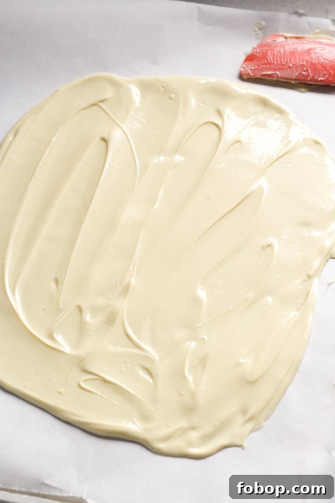 Gluten-Free White Chocolate Peppermint Bark Recipe 9 Spread out white chocolate on a parchment-lined sheet pan.