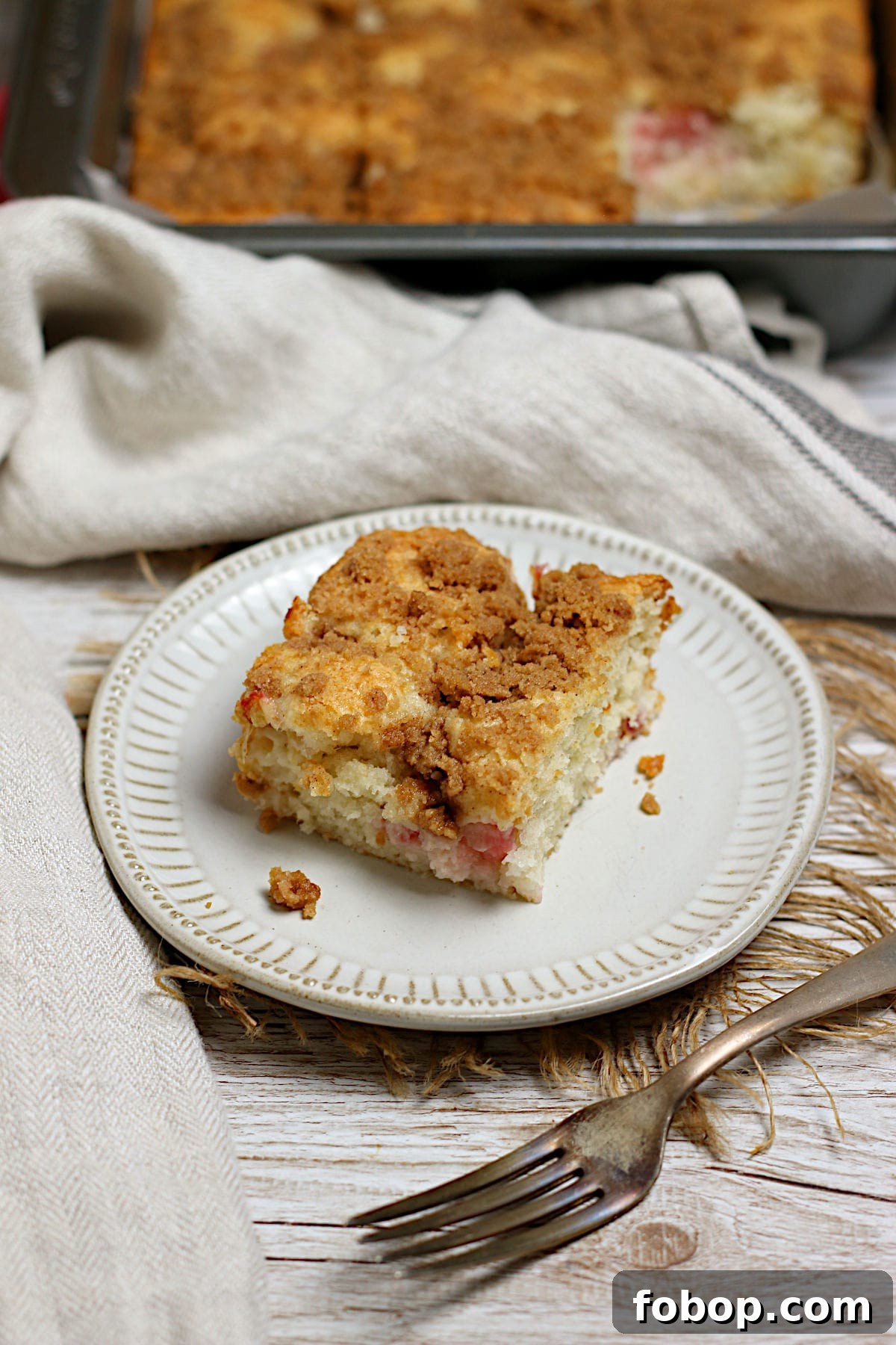 Moist Rhubarb Coffee Cake with Greek Yogurt 3 Greek Yogurt Rhubarb Coffee Cake on a small white plate.