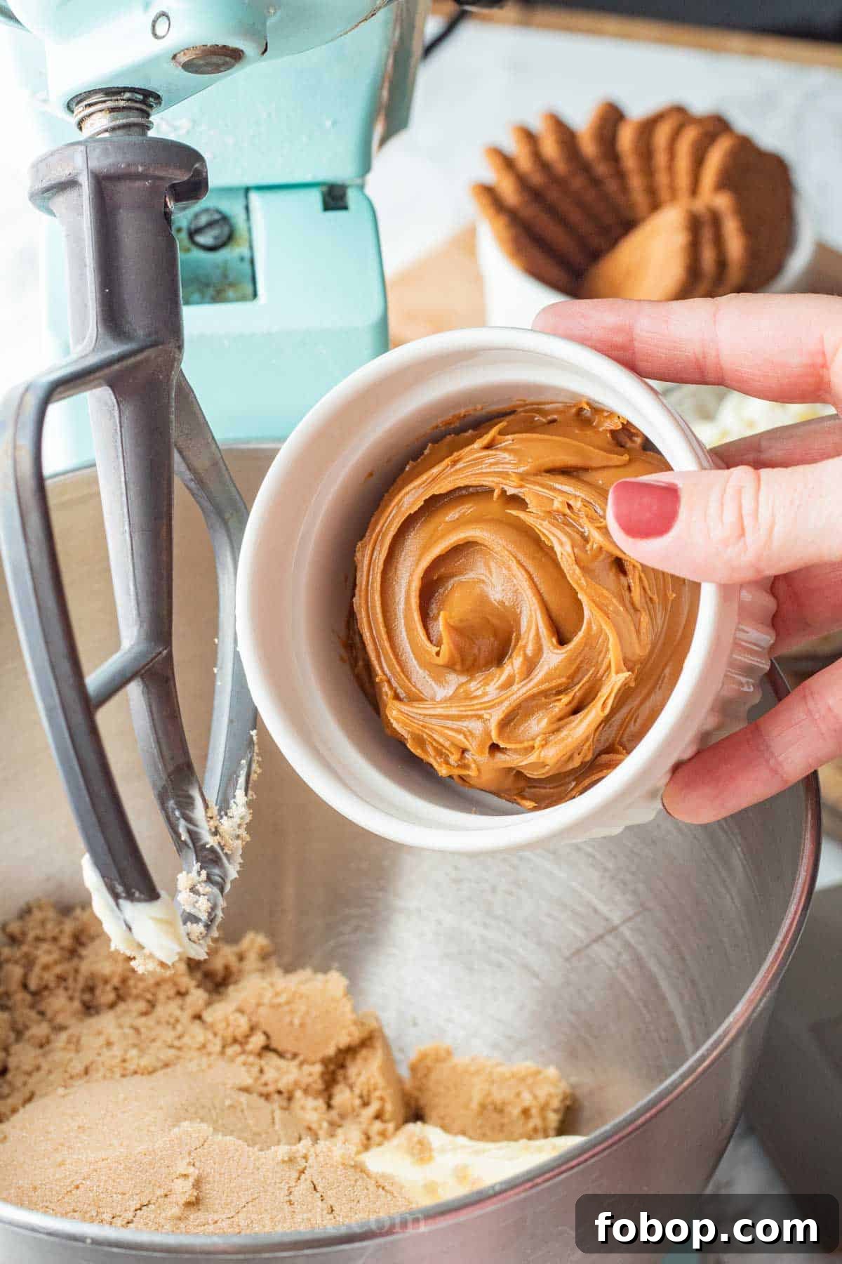White Chocolate Biscoff Cookie Recipe: Crunchy Layered Cookies 4 White bowl of cookie butter pouring into metal mixing bowl.