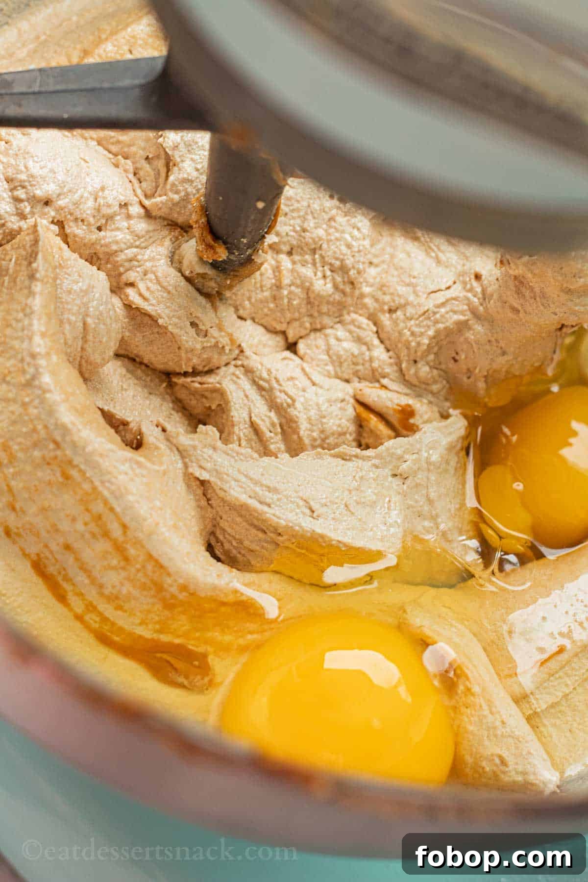 White Chocolate Biscoff Cookie Recipe: Crunchy Layered Cookies 5 Raw eggs in sugar and butter mixture for cookies in metal mixing bowl.