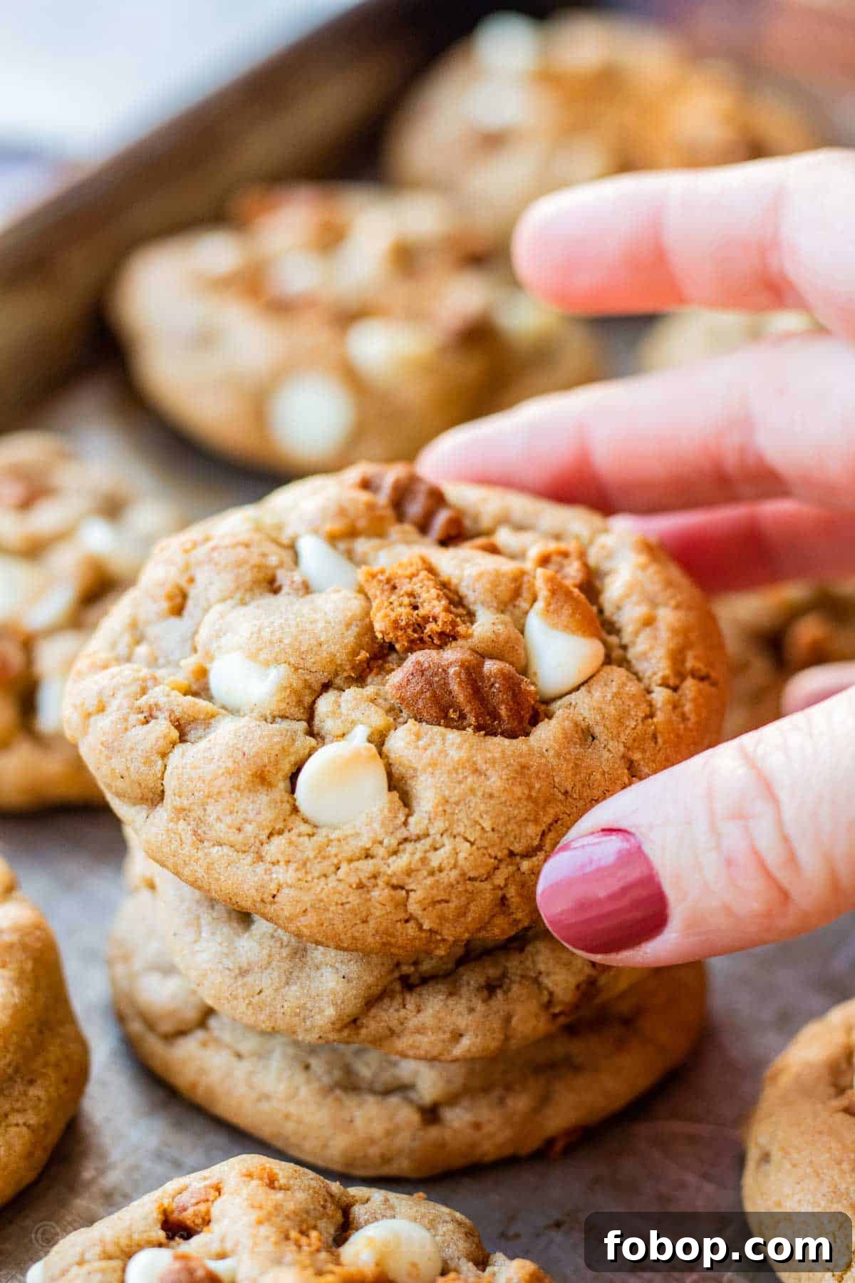 White Chocolate Biscoff Cookie Recipe: Crunchy Layered Cookies 9 Stack of 3 baked white chocolate biscoff cookies on metal baking sheet.