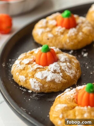 Baked pumpkin sugar cookies on plate.