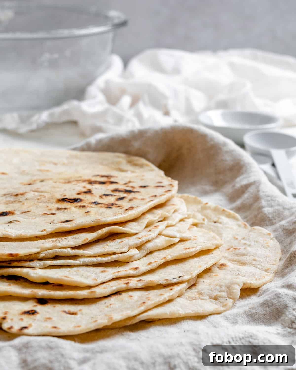 Handmade Flour Tortillas: Authentic Homemade Tortilla Recipe 2 completed Tortillas de Harina – Handmade Flour Tortillas stacked on one another against a white surface