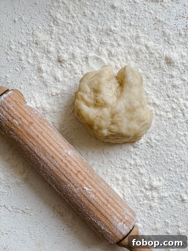 Handmade Flour Tortillas: Authentic Homemade Tortilla Recipe 11 process shot showing piece of dough alongside rolling pin