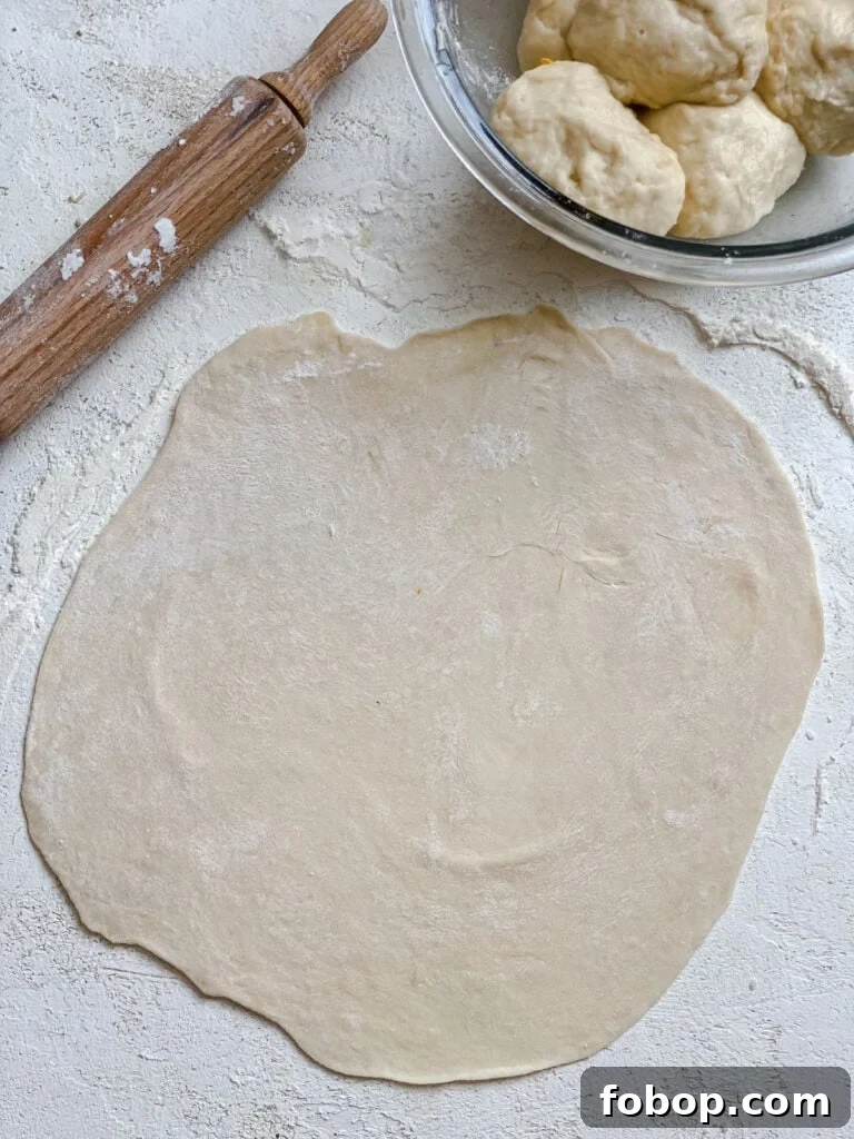 Handmade Flour Tortillas: Authentic Homemade Tortilla Recipe 12 process shot showing rolled out dough against a white surface