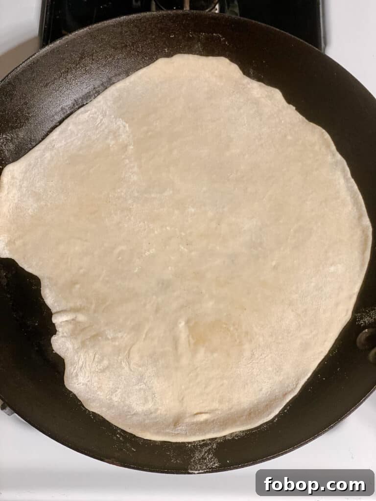 Handmade Flour Tortillas: Authentic Homemade Tortilla Recipe 13 process shot showing rolled out dough on pan
