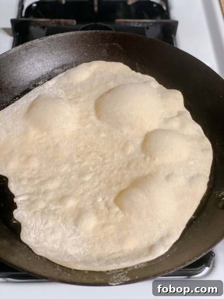 Handmade Flour Tortillas: Authentic Homemade Tortilla Recipe 14 process shot showing tortilla cooking on pan