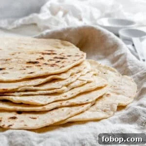 Handmade Flour Tortillas: Authentic Homemade Tortilla Recipe 16 completed Tortillas de Harina – Handmade Flour Tortillas stacked on one another against a white surface