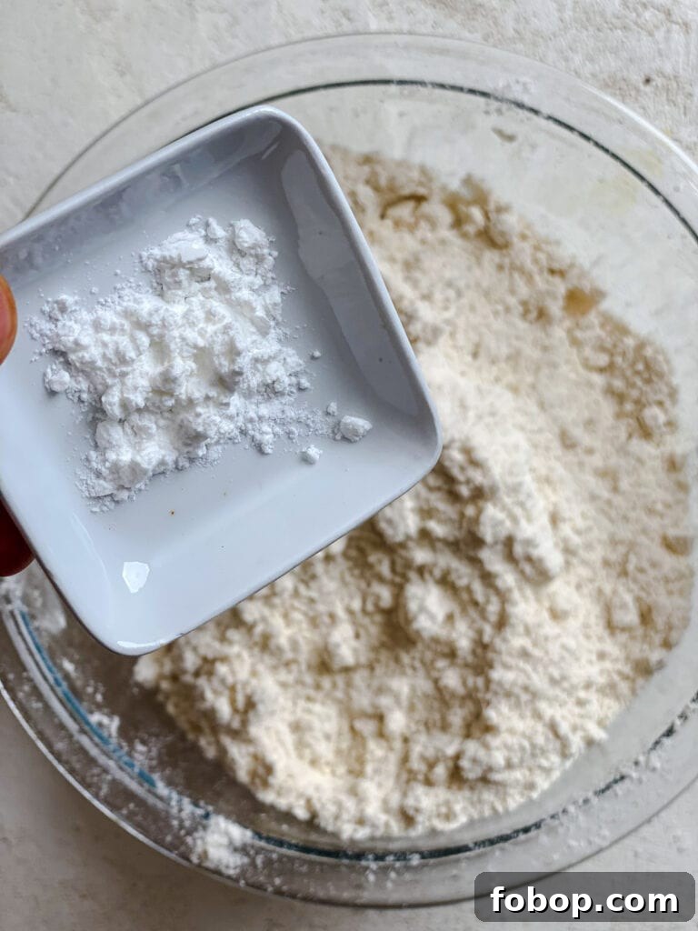 Handmade Flour Tortillas: Authentic Homemade Tortilla Recipe 5 process shot of adding baking powder to mixing bowl