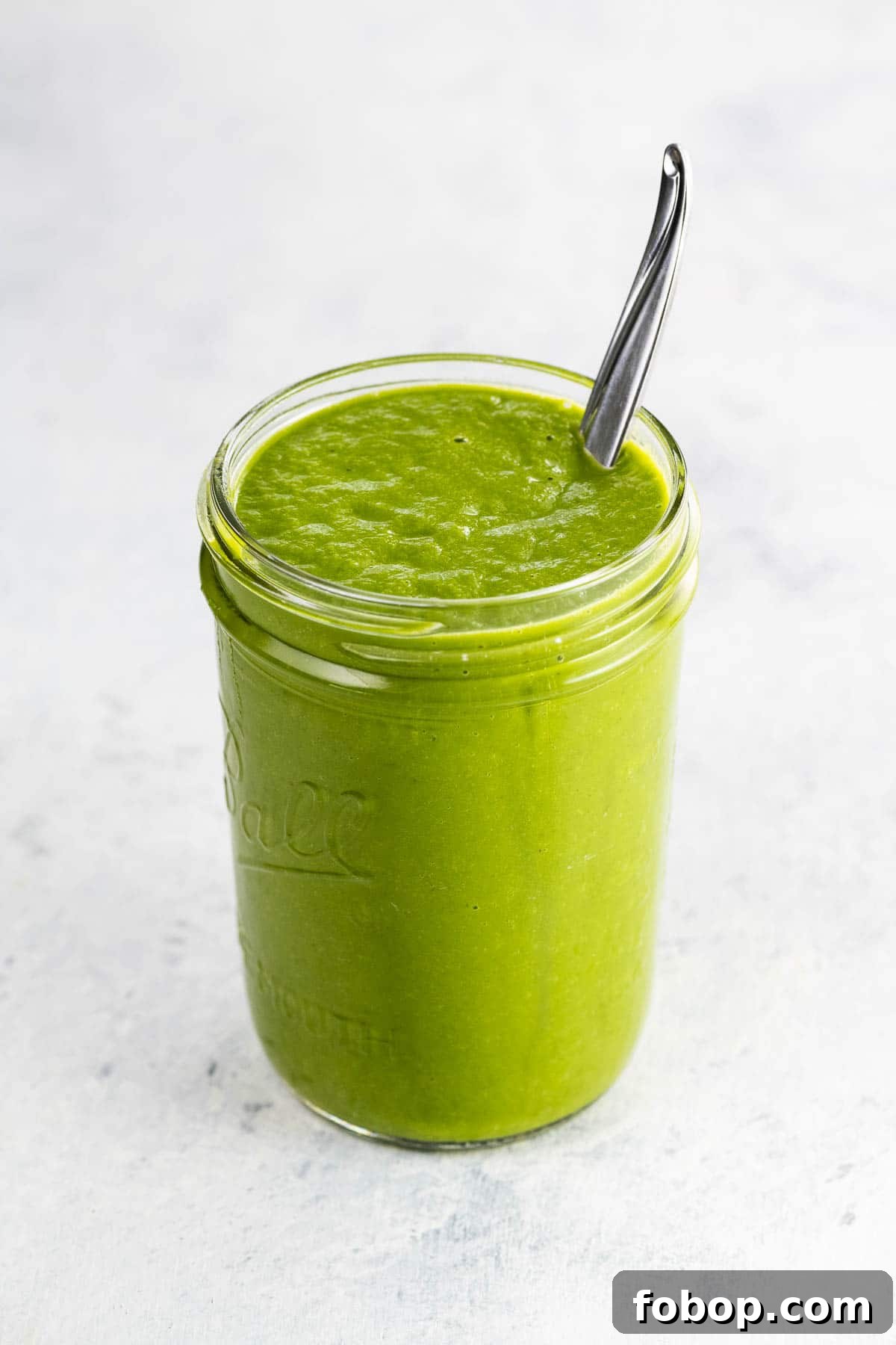 Authentic Green Enchilada Sauce Recipe for Flavorful Enchiladas 2 green enchilada sauce in a jar with a spoon