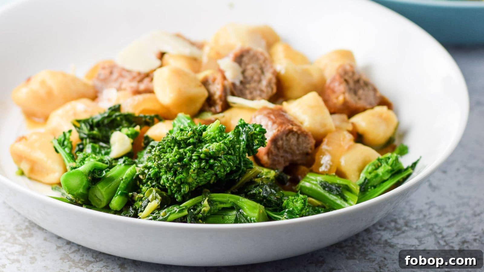 17 Flavor-Packed Side Dishes to Elevate Any Meal 17 a deep plate with the broccoli rabe with gnocchi and sausage