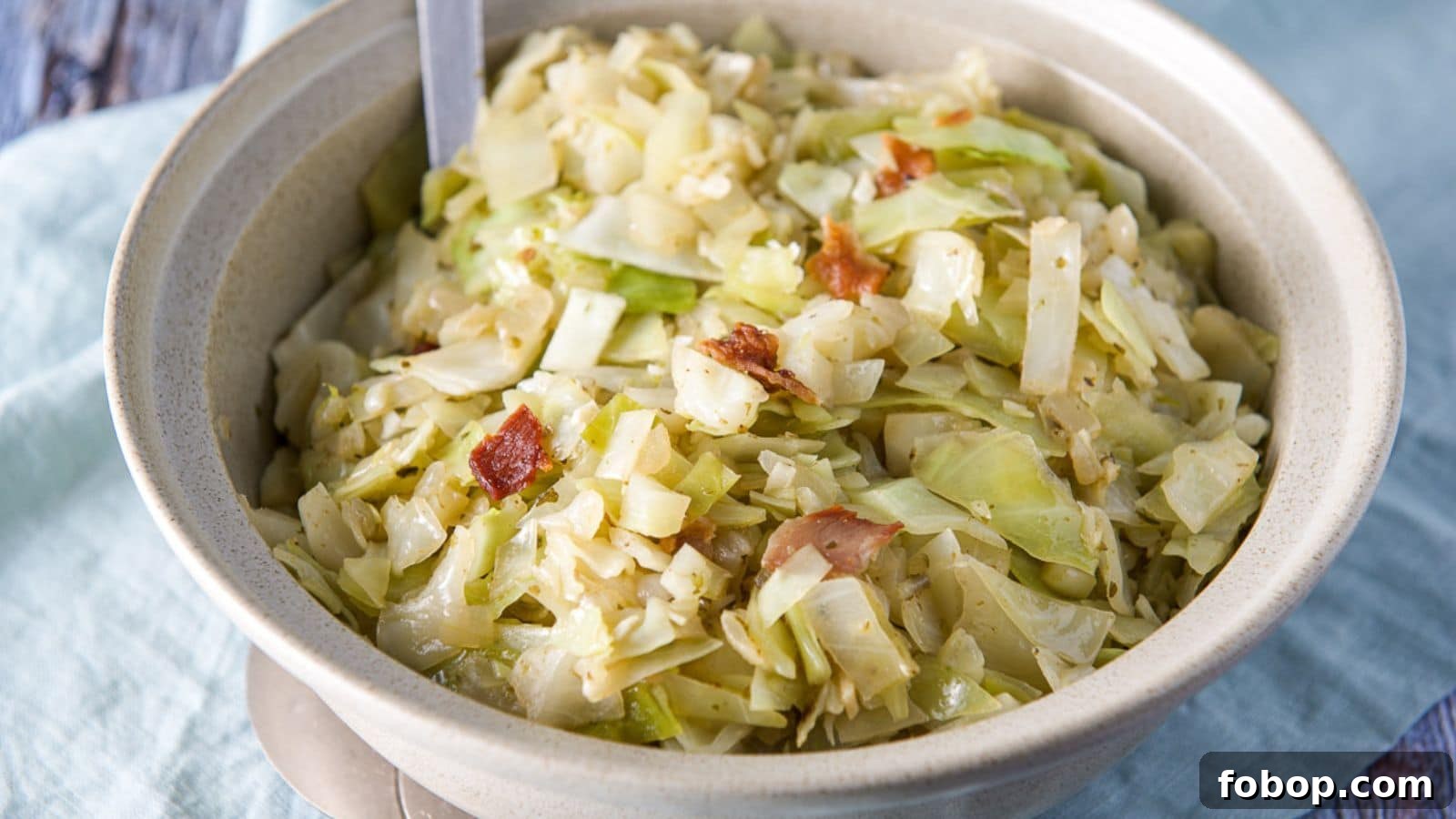 17 Flavor-Packed Side Dishes to Elevate Any Meal 3 A bowl with cabbage and bacon on a blue napkin