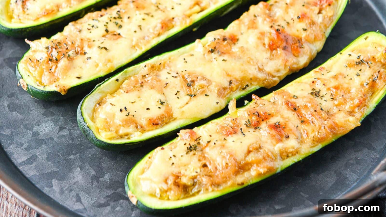 17 Flavor-Packed Side Dishes to Elevate Any Meal 5 a metal dish with zucchini halves with melted cheese on top