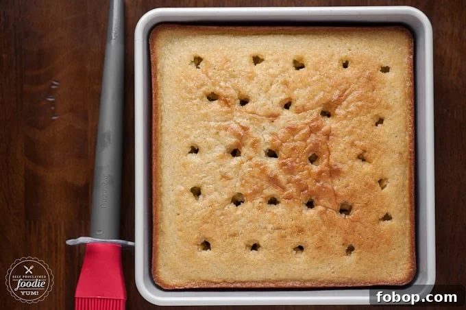 vanilla cake in pan with holes punched into it for a poke cake recipes