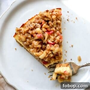 Cottage Cheese Cheesecake on a white plate with a fork on it.