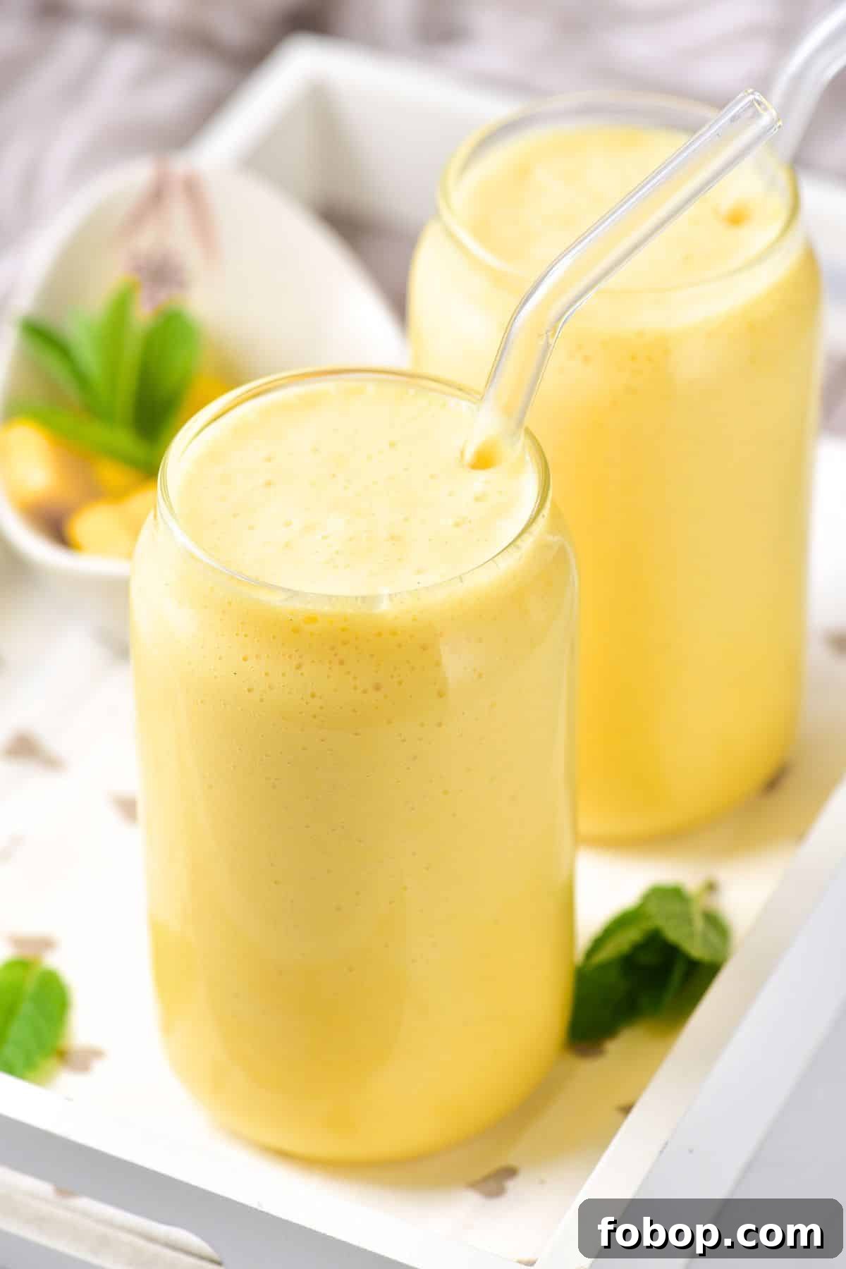 Glasses of creamy mango milkshake.