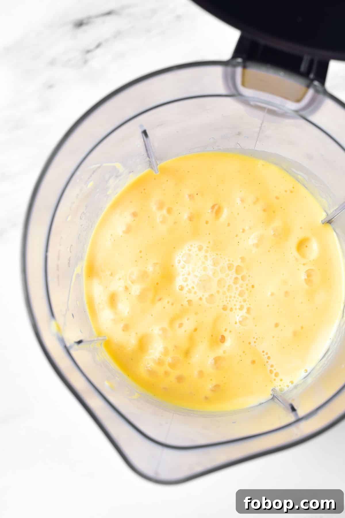 Blended mango shake in blender