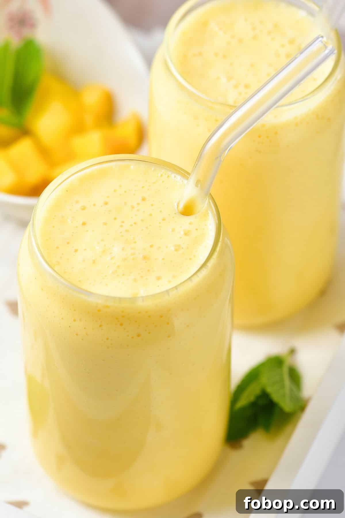 Up close shot of a glass of mango milkshake