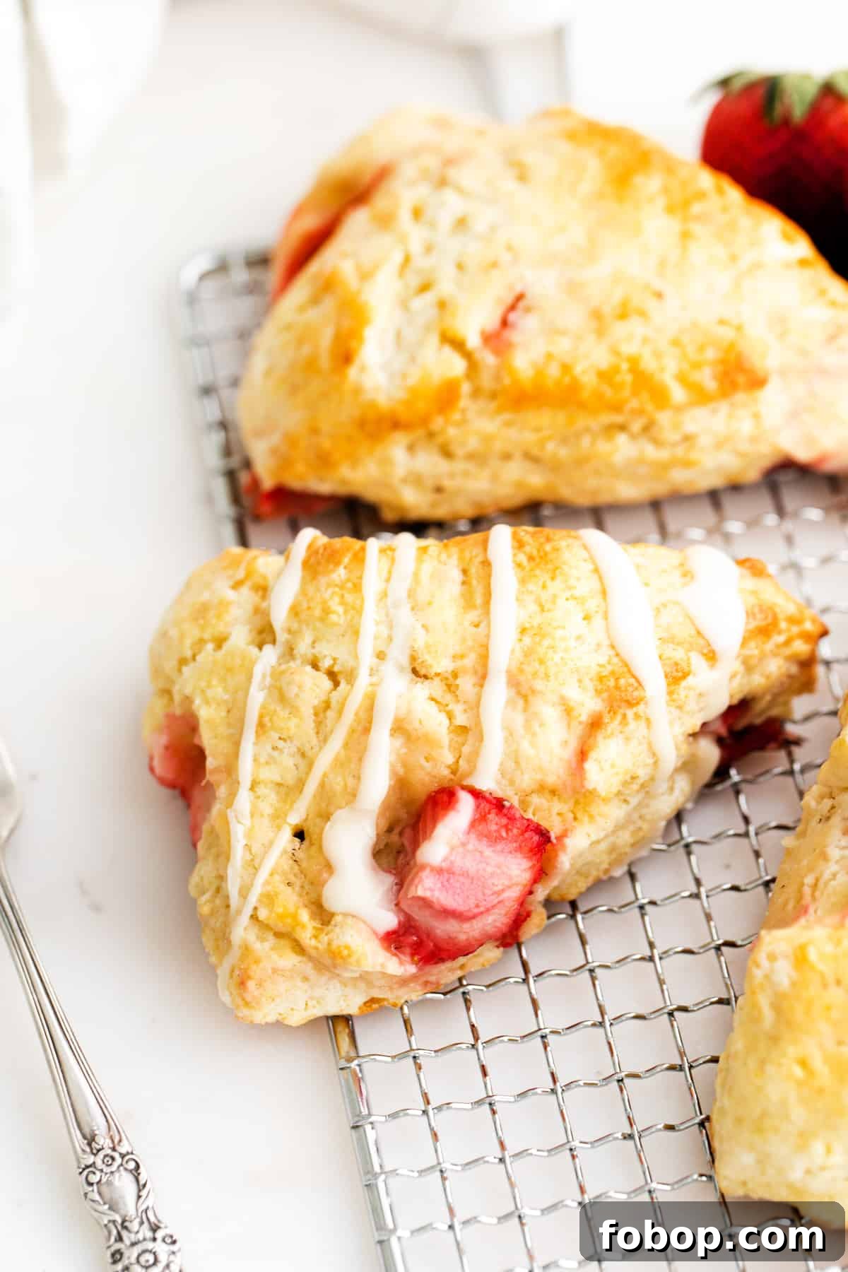 Fresh strawberry scones drizzled with vanilla glaze