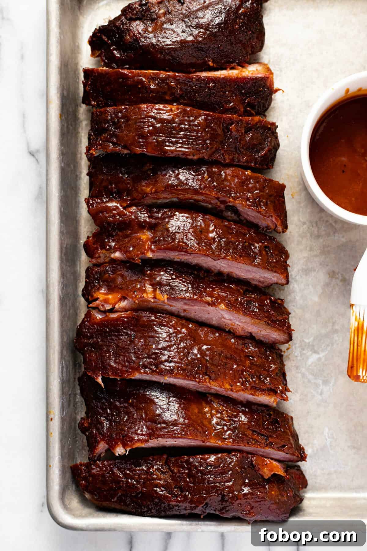 Smoked Baby Back Ribs: Tender, Flavorful Recipe for Beginners 12 Overhead shot of a sheet pan with sliced baby back ribs on it.