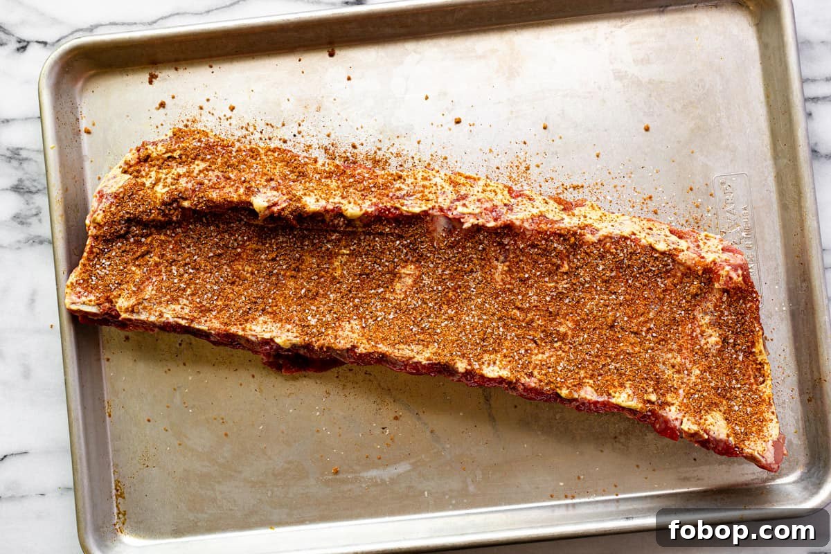 Smoked Baby Back Ribs: Tender, Flavorful Recipe for Beginners 4 Sheet pan with seasoned baby back ribs.