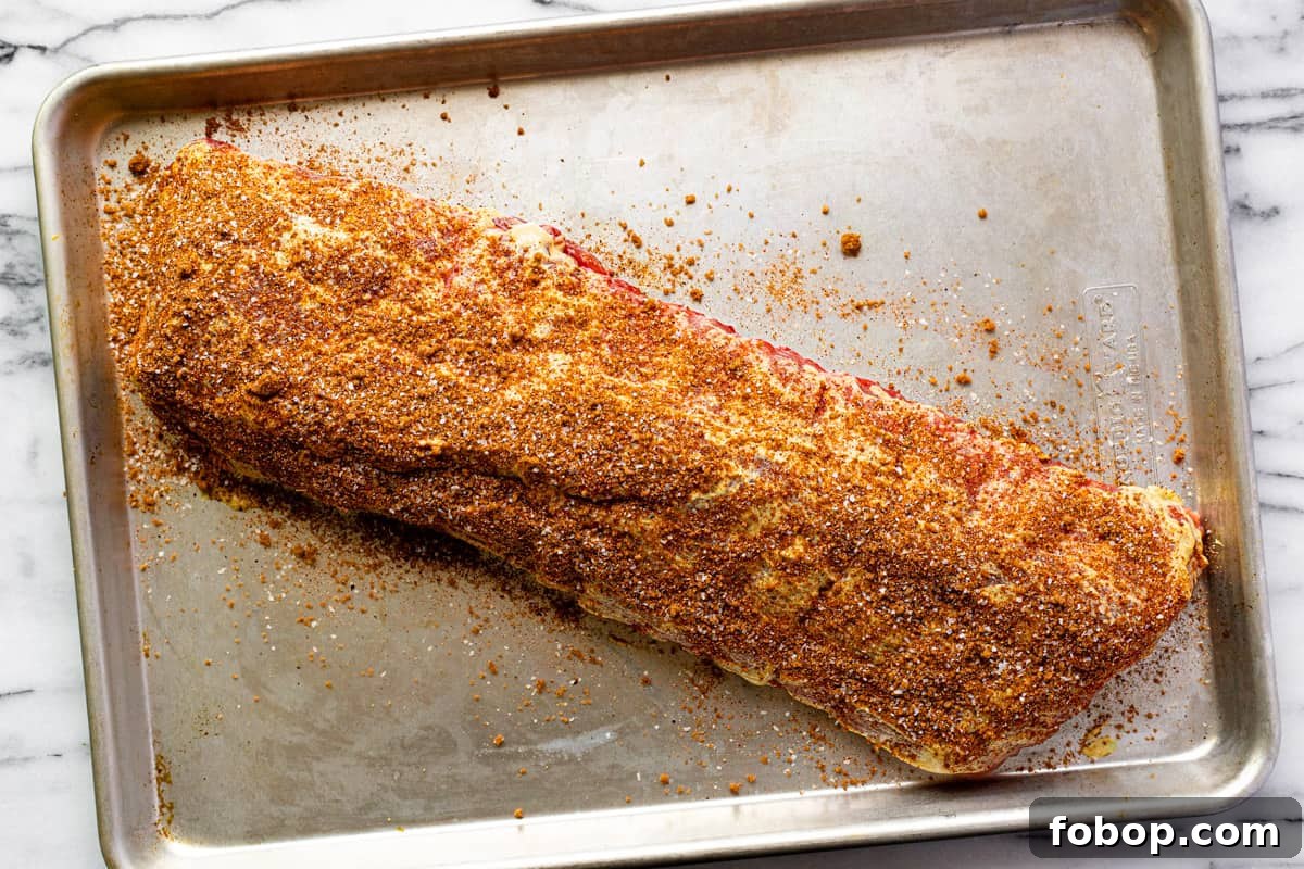 Smoked Baby Back Ribs: Tender, Flavorful Recipe for Beginners 5 Sheet pan with seasoned baby back ribs.